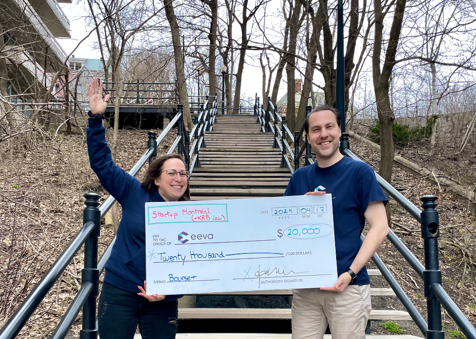 Adrienne and Jarrod pose holding their giant check!