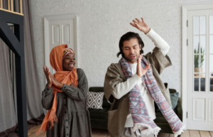 Woman and man dance in living room