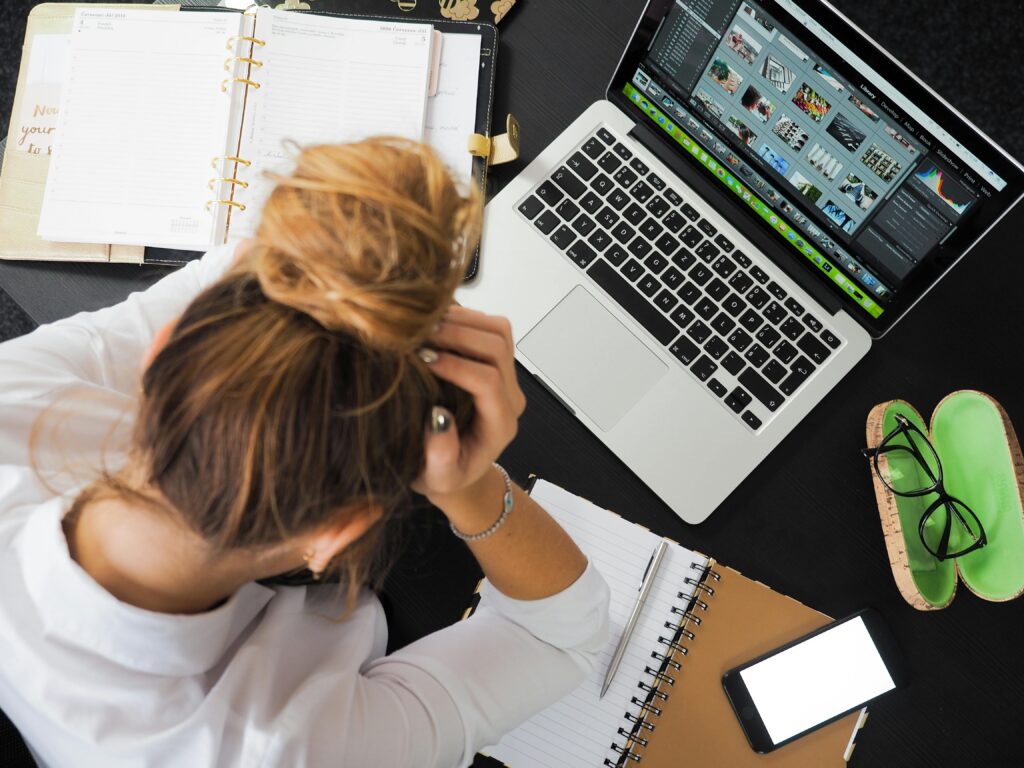 Woman in front of computer looking stressed