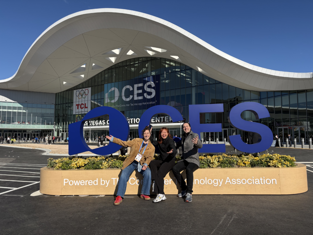 3 members of the eeva team post outside the CES center, in front of the large CES sign
